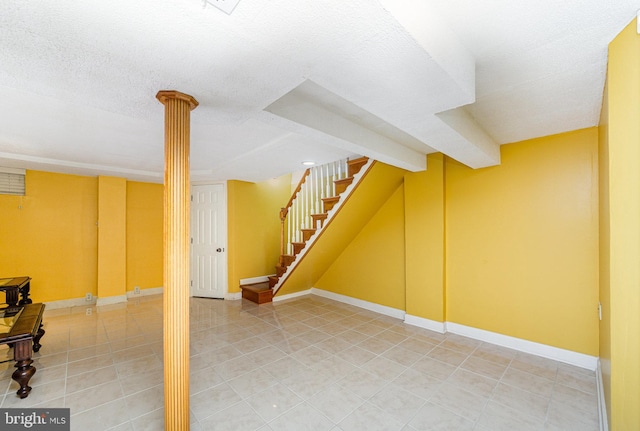 833 Evesham Ave, Baltimore, MD 21212 - finished basement featuring light tile patterned flooring, a textured ceiling, and stairs