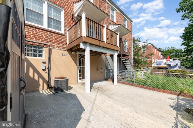 833 Evesham Ave, Baltimore, MD 21212 - rear view of house featuring brick siding, a patio area, a deck, and stairway