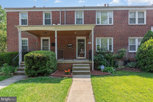 833 Evesham Ave, Baltimore, MD 21212 - multi unit property with brick siding, a front lawn, and a porch