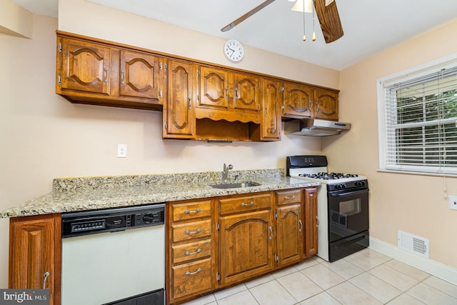 833 Evesham Ave, Baltimore, MD 21212 - kitchen with dishwasher, range with gas stovetop, under cabinet range hood, a ceiling fan, and light tile patterned flooring
