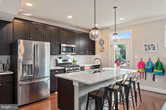 103 Norma Aly, Annapolis, MD 21403 - kitchen featuring appliances with stainless steel finishes, dark wood-style flooring, tasteful backsplash, recessed lighting, and a center island with sink