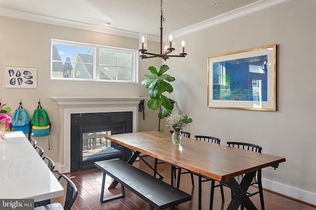 103 Norma Aly, Annapolis, MD 21403 - dining room featuring a chandelier, dark wood-style flooring, a multi sided fireplace, and crown molding
