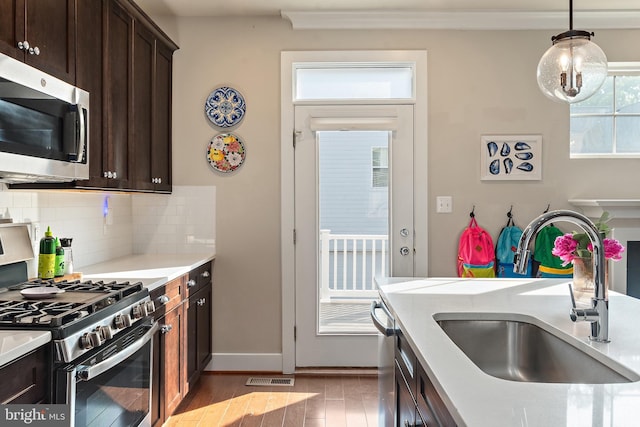 103 Norma Aly, Annapolis, MD 21403 - kitchen featuring appliances with stainless steel finishes, light countertops, dark brown cabinets, and crown molding