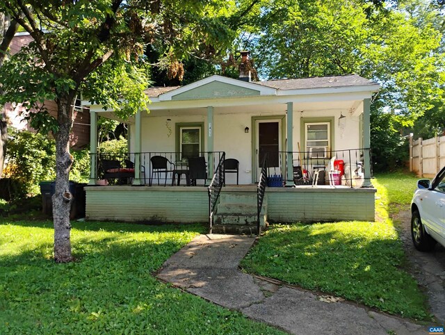 1411 Vine St, Charlottesville, VA 22902 - bungalow-style house featuring a porch, a front lawn, stucco siding, and a chimney