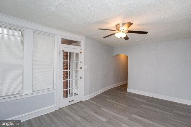 7152 N 20th St, Philadelphia, PA 19138 - spare room with arched walkways, wood finished floors, a ceiling fan, and a textured ceiling