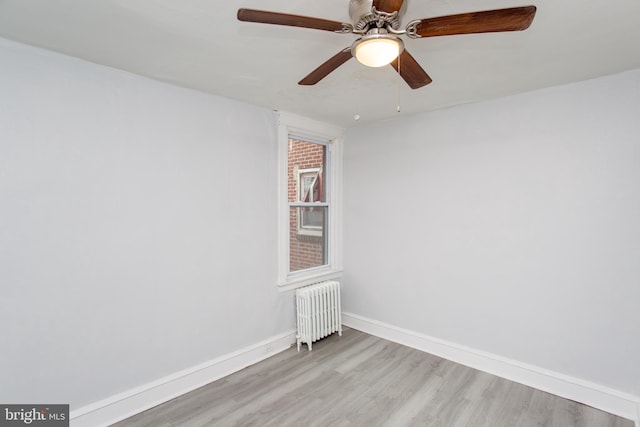 7152 N 20th St, Philadelphia, PA 19138 - empty room featuring radiator heating unit, light wood-type flooring, and a ceiling fan