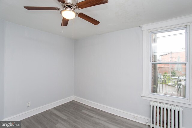 7152 N 20th St, Philadelphia, PA 19138 - empty room with radiator heating unit, wood finished floors, and a ceiling fan