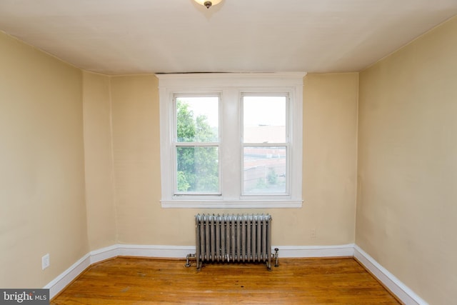 7152 N 20th St, Philadelphia, PA 19138 - empty room featuring radiator heating unit and wood finished floors