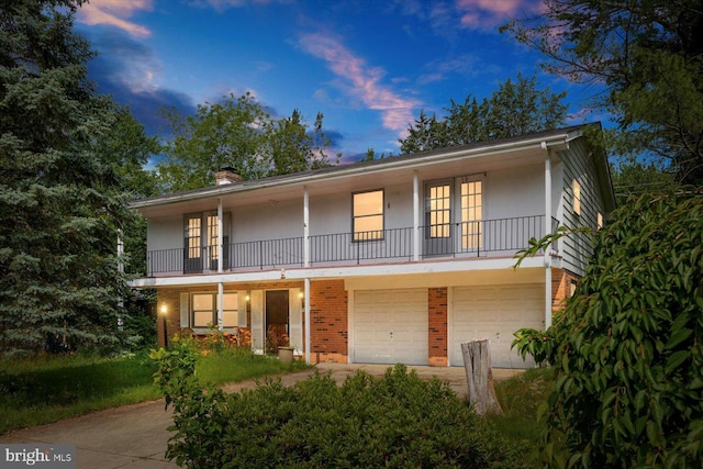 1605 N Amelia St, Sterling, VA 20164 - view of front of property with french doors, a balcony, brick siding, a garage, and a chimney