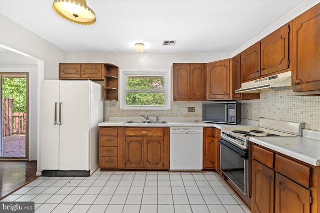 1605 N Amelia St, Sterling, VA 20164 - kitchen with white appliances, under cabinet range hood, open shelves, and healthy amount of natural light