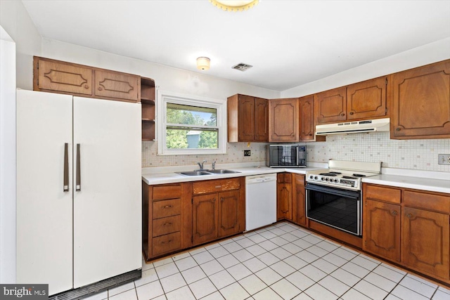 1605 N Amelia St, Sterling, VA 20164 - kitchen featuring white appliances, under cabinet range hood, light countertops, and tasteful backsplash