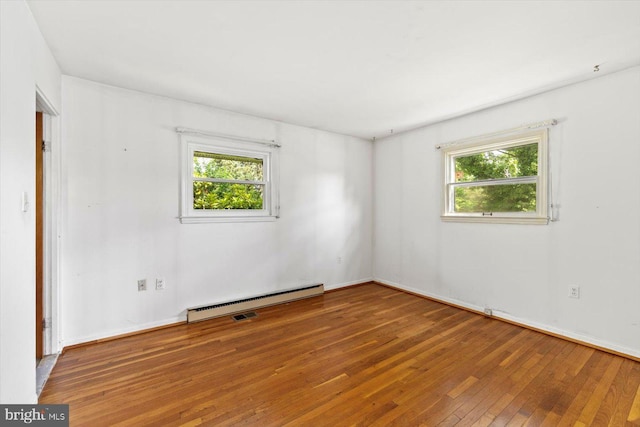 1605 N Amelia St, Sterling, VA 20164 - empty room with a baseboard heating unit, plenty of natural light, and hardwood / wood-style flooring