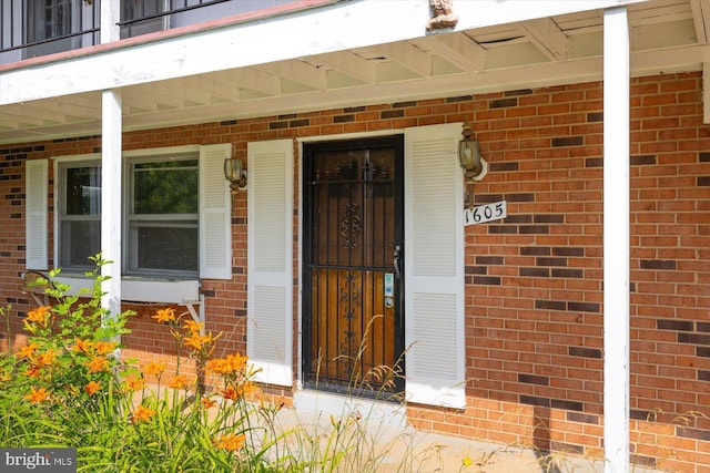 1605 N Amelia St, Sterling, VA 20164 - view of exterior entry with brick siding, a porch, and a balcony