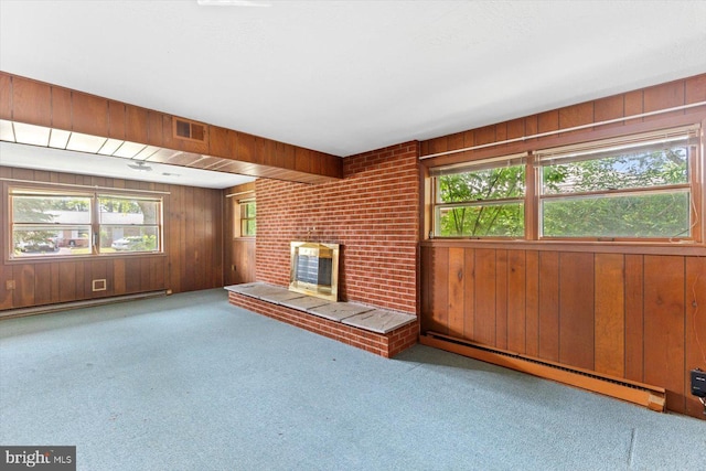 1605 N Amelia St, Sterling, VA 20164 - unfurnished living room featuring a baseboard heating unit, wooden walls, carpet floors, and plenty of natural light