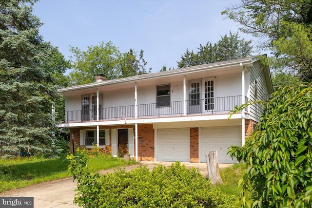 1605 N Amelia St, Sterling, VA 20164 - view of front of property featuring brick siding, a garage, a balcony, and a chimney
