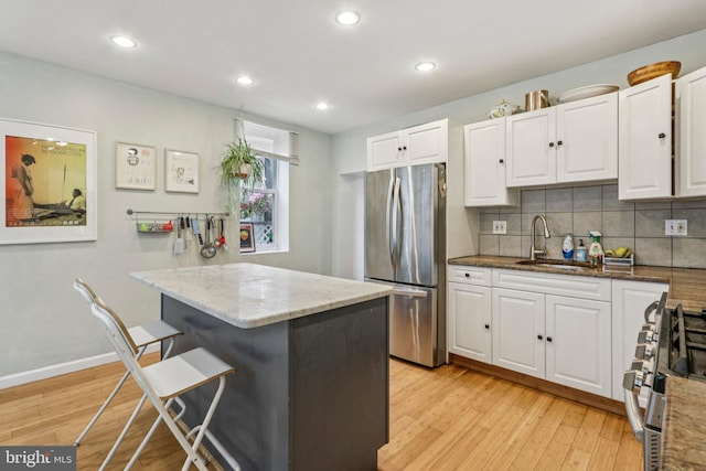 455 Krams Ave, Philadelphia, PA 19128 - kitchen with appliances with stainless steel finishes, white cabinetry, backsplash, light stone countertops, and recessed lighting