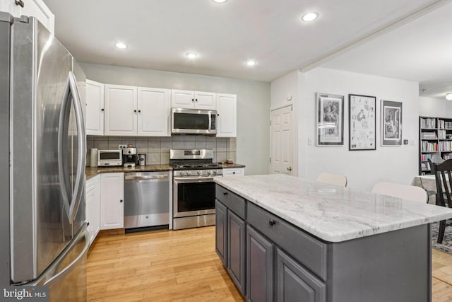 455 Krams Ave, Philadelphia, PA 19128 - kitchen featuring stainless steel appliances, white cabinets, tasteful backsplash, recessed lighting, and a center island