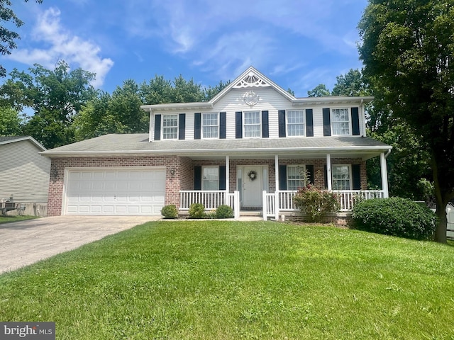 425 Lexington Way, Littlestown, PA 17340 - view of front of home featuring an attached garage, driveway, covered porch, a front yard, and brick siding