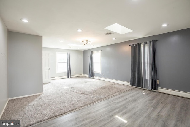 214 Crooked Ln, King Of Prussia, PA 19406 - empty room featuring a skylight, wood finished floors, recessed lighting, and baseboard heating