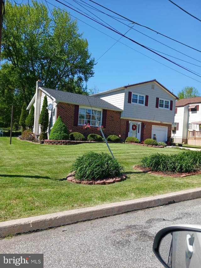 30 Belvue Ter, Aston, PA 19014 - tri-level home with brick siding, an attached garage, and a front yard