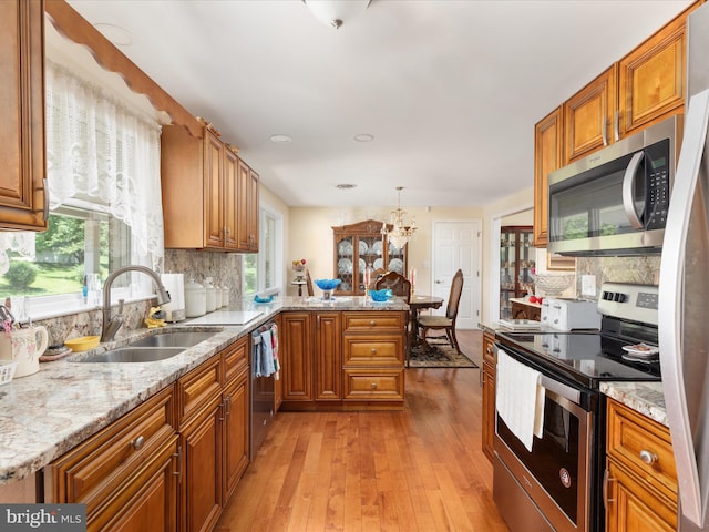 5409 Greenspring Valley Rd, Green Spring, WV 26722 - kitchen with appliances with stainless steel finishes, brown cabinets, and a peninsula