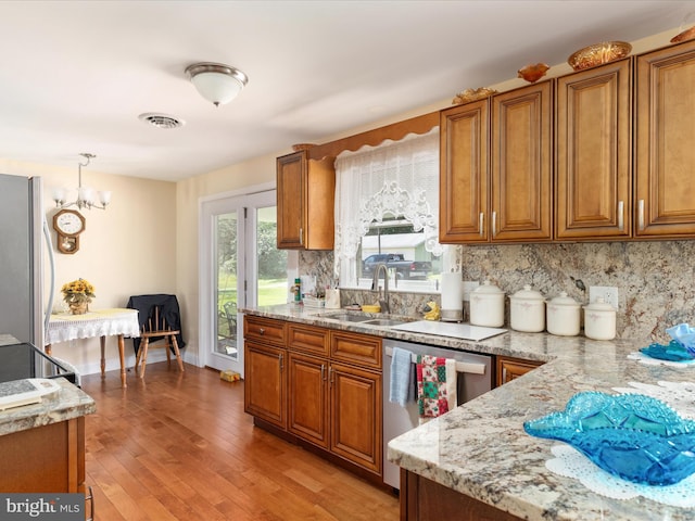 5409 Greenspring Valley Rd, Green Spring, WV 26722 - kitchen with brown cabinets, stainless steel dishwasher, decorative backsplash, and freestanding refrigerator