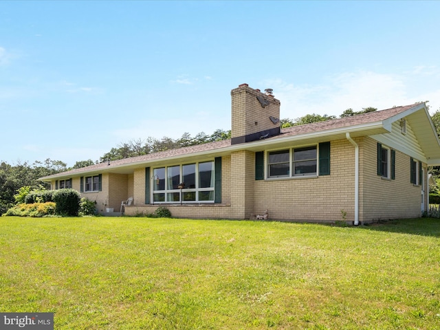 5409 Greenspring Valley Rd, Green Spring, WV 26722 - view of front of property with a chimney, a front lawn, brick siding, and a shingled roof