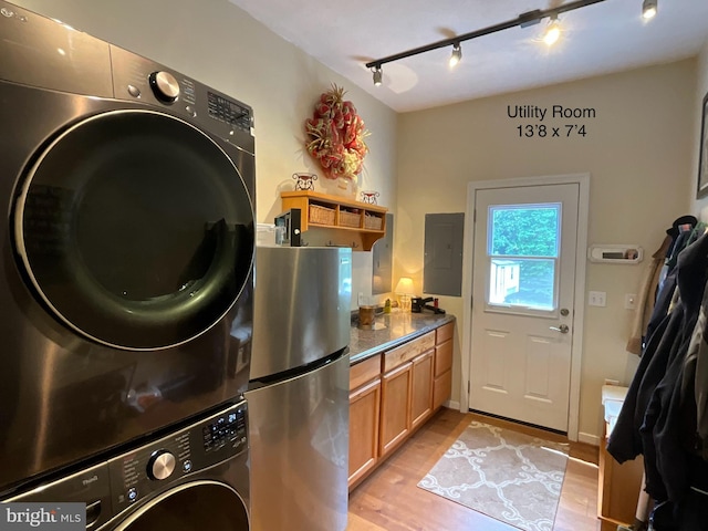 6197 Fishermans Way, Mechanicsville, VA 23116 - laundry room featuring stacked washer / dryer, track lighting, electric panel, and light wood finished floors