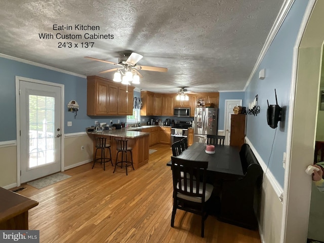 6197 Fishermans Way, Mechanicsville, VA 23116 - dining area featuring a textured ceiling, a ceiling fan, light wood-type flooring, healthy amount of natural light, and crown molding