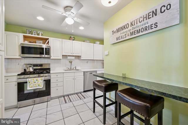 15 Paul Rd, Maple Shade, NJ 08052 - kitchen with stainless steel appliances, white cabinets, tasteful backsplash, a ceiling fan, and recessed lighting
