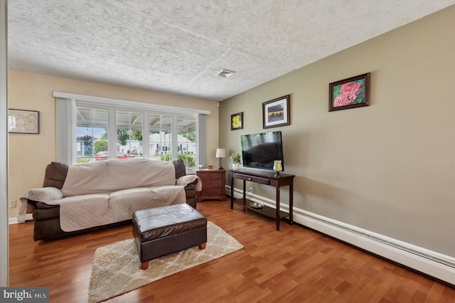 15 Paul Rd, Maple Shade, NJ 08052 - living area featuring wood finished floors, a baseboard radiator, and a textured ceiling