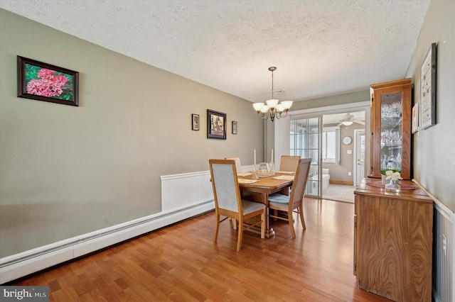 15 Paul Rd, Maple Shade, NJ 08052 - dining room with baseboard heating, a textured ceiling, light wood-style flooring, a chandelier, and wainscoting