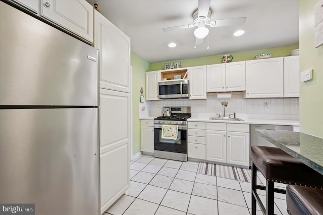 15 Paul Rd, Maple Shade, NJ 08052 - kitchen with appliances with stainless steel finishes, ceiling fan, white cabinetry, tasteful backsplash, and recessed lighting