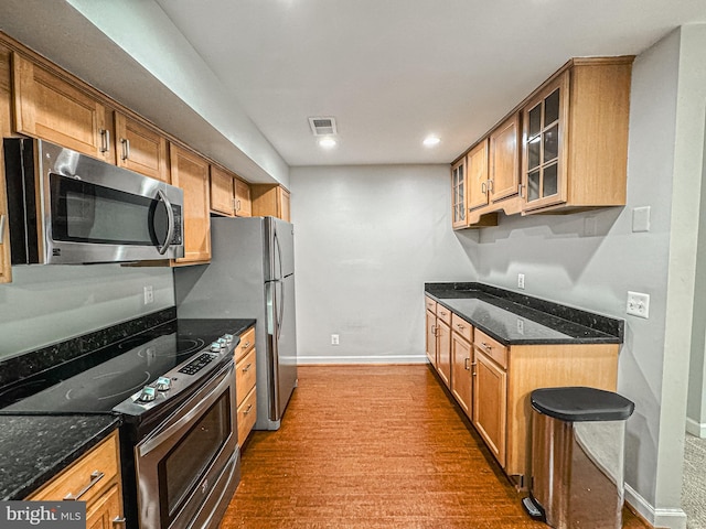 3801 Ridge Knoll Ct Unit 206A, Fairfax, VA 22033 - kitchen featuring stainless steel appliances, carpet, glass insert cabinets, dark stone countertops, and recessed lighting
