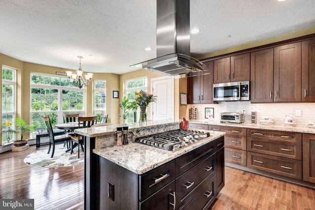 4136 Shanelle Ct Lot 10, Hampstead, MD 21074 - kitchen with stainless steel appliances, island exhaust hood, light wood-style floors, a chandelier, and light stone counters