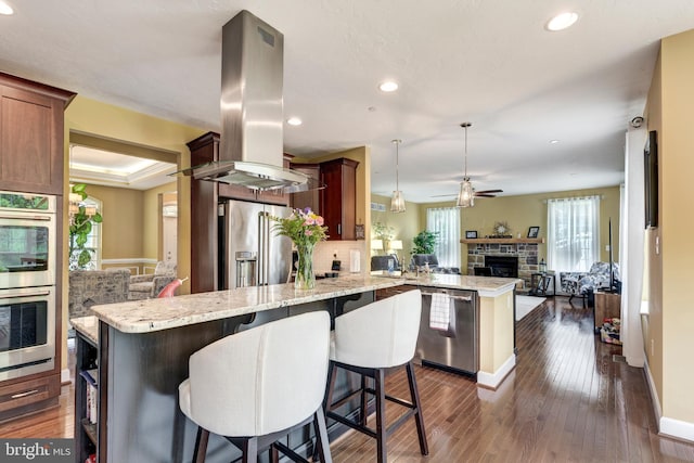 4136 Shanelle Ct Lot 10, Hampstead, MD 21074 - kitchen with island range hood, a peninsula, stainless steel appliances, open floor plan, and a ceiling fan