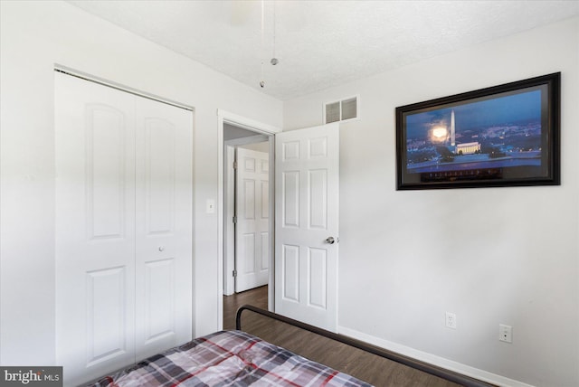 1215 Lorene Dr, Pasadena, MD 21122 - bedroom featuring wood finished floors, a closet, and a textured ceiling