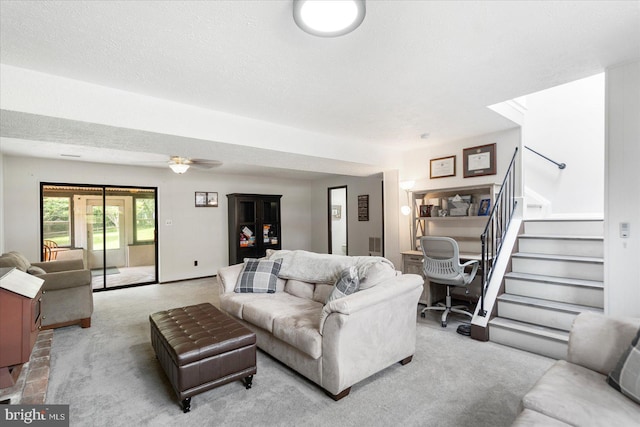 1215 Lorene Dr, Pasadena, MD 21122 - living room with light colored carpet, stairway, and ceiling fan