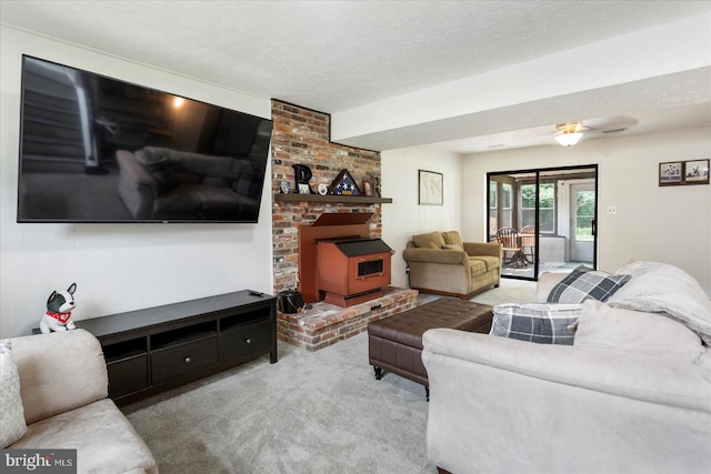 1215 Lorene Dr, Pasadena, MD 21122 - carpeted living room featuring a wood stove, a textured ceiling, and a ceiling fan