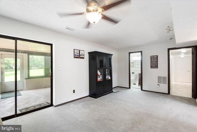 1215 Lorene Dr, Pasadena, MD 21122 - unfurnished bedroom with light colored carpet, a textured ceiling, ensuite bath, and ceiling fan