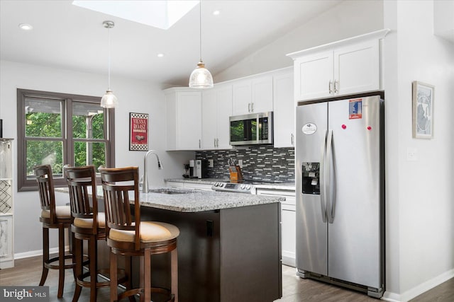1215 Lorene Dr, Pasadena, MD 21122 - kitchen featuring stainless steel appliances, tasteful backsplash, white cabinetry, an island with sink, and dark wood finished floors