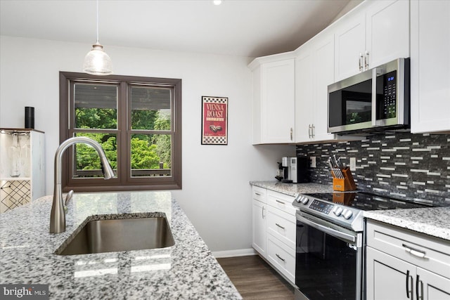1215 Lorene Dr, Pasadena, MD 21122 - kitchen featuring stainless steel appliances, decorative backsplash, white cabinetry, dark wood-style floors, and light stone counters