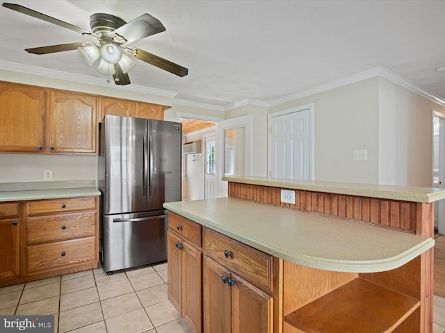 1440 Cedarhurst Rd, Shady Side, MD 20764 - kitchen featuring freestanding refrigerator, ornamental molding, light countertops, a center island, and brown cabinets