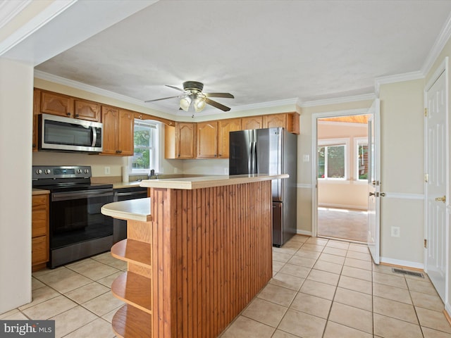 1440 Cedarhurst Rd, Shady Side, MD 20764 - kitchen featuring appliances with stainless steel finishes, light countertops, light tile patterned floors, ceiling fan, and crown molding