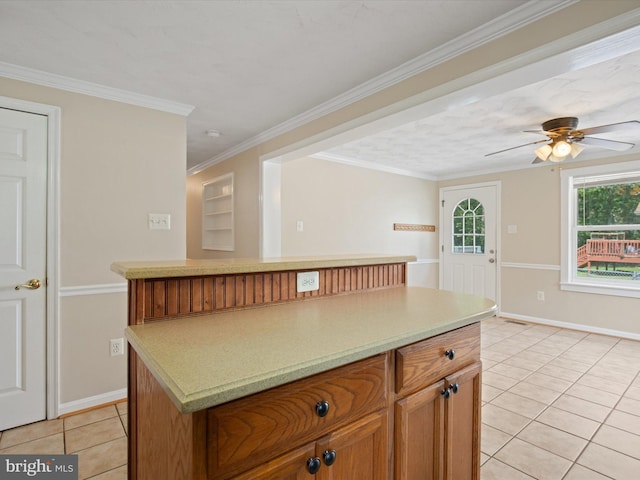 1440 Cedarhurst Rd, Shady Side, MD 20764 - kitchen with light tile patterned flooring, a kitchen island, light countertops, a ceiling fan, and crown molding