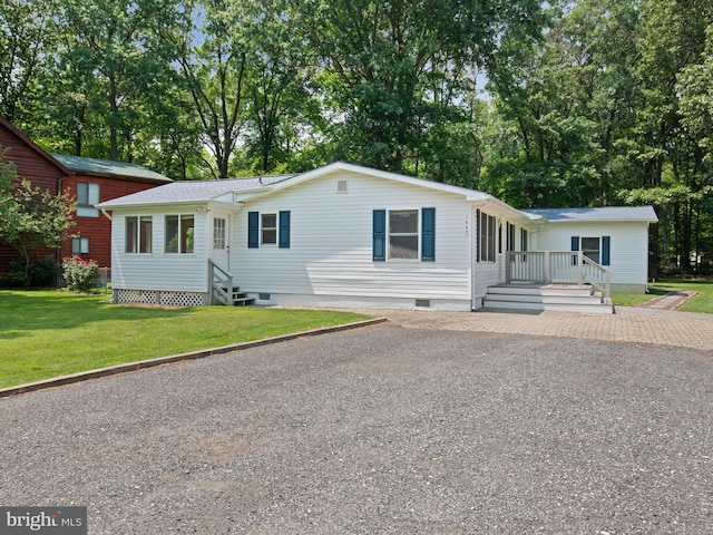 1440 Cedarhurst Rd, Shady Side, MD 20764 - view of front of house featuring crawl space, a front lawn, driveway, and view of scattered trees