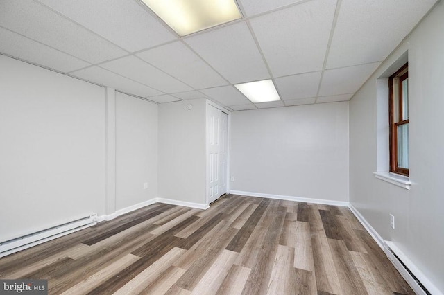 27 E Spring St, Frackville, PA 17931 - spare room with a baseboard heating unit, a paneled ceiling, and wood finished floors