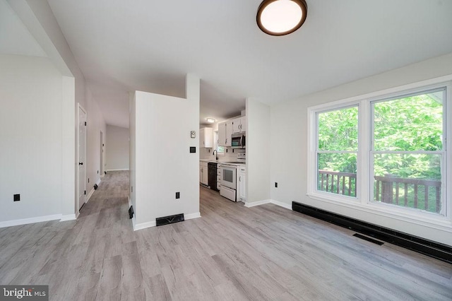27 E Spring St, Frackville, PA 17931 - unfurnished living room featuring light wood finished floors and baseboards