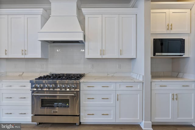 7108 River Drive Rd, Sparrows Point, MD 21219 - kitchen featuring appliances with stainless steel finishes, custom range hood, white cabinetry, and decorative backsplash