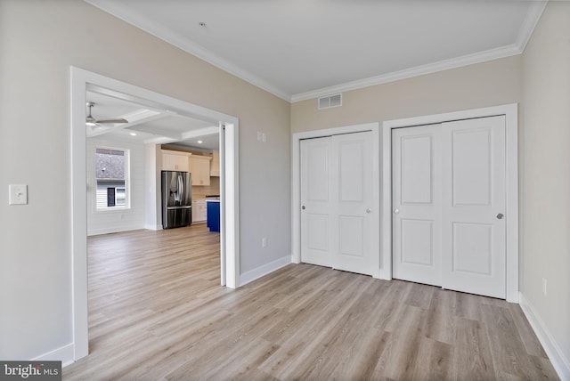 7108 River Drive Rd, Sparrows Point, MD 21219 - unfurnished bedroom with stainless steel fridge, crown molding, light wood finished floors, multiple closets, and beam ceiling